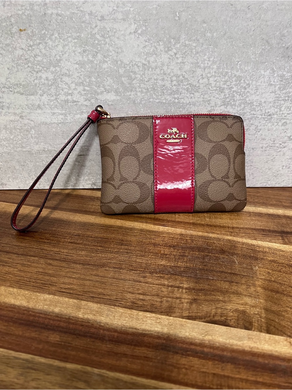 COACH Brown Signature Canvas Wristlet with Pink Patent Center